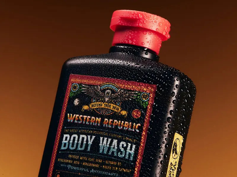 Men's skincare product bottle covered in water droplets, emphasizing hydration and bold packaging design.